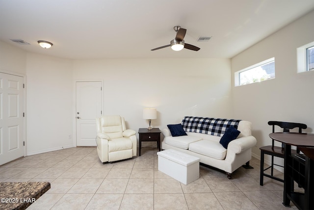 tiled living room featuring ceiling fan