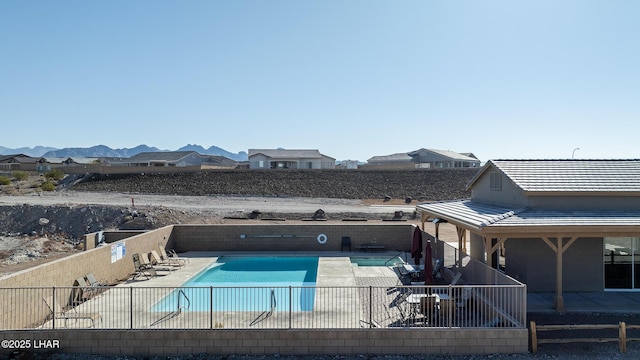 view of pool featuring a mountain view and a patio