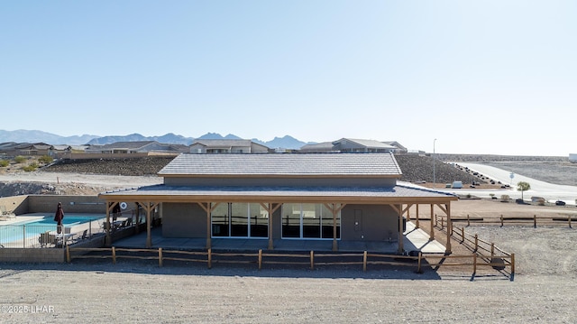 rear view of property featuring a mountain view