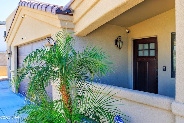 2930 Poseidon Ln, Lake Havasu City, AZ 86404 - doorway to property featuring stucco siding, a security system, and a garage