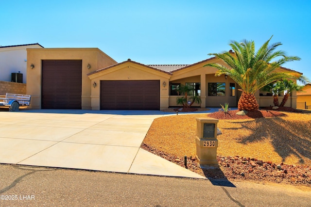 2930 Poseidon Ln, Lake Havasu City, AZ 86404 - view of front of property with an attached garage, stucco siding, driveway, and a tiled roof