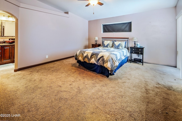 2930 Poseidon Ln, Lake Havasu City, AZ 86404 - bedroom with light carpet, lofted ceiling, arched walkways, ensuite bathroom, and a ceiling fan