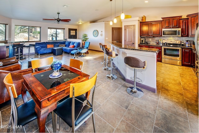 2930 Poseidon Ln, Lake Havasu City, AZ 86404 - kitchen featuring stainless steel appliances, a ceiling fan, lofted ceiling, backsplash, and a breakfast bar