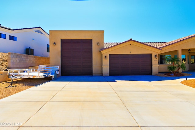 2930 Poseidon Ln, Lake Havasu City, AZ 86404 - view of front facade with concrete driveway, an attached garage, stucco siding, a tile roof, and fence