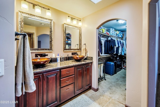 2930 Poseidon Ln, Lake Havasu City, AZ 86404 - bathroom with double vanity, a spacious closet, and tile patterned floors
