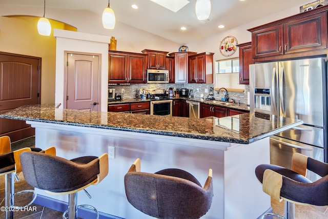 2930 Poseidon Ln, Lake Havasu City, AZ 86404 - kitchen featuring dark brown cabinets, stainless steel appliances, a sink, tasteful backsplash, and vaulted ceiling