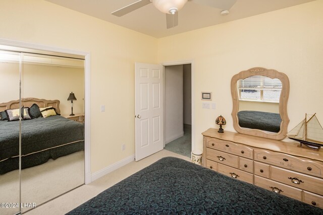 bedroom featuring light carpet and ceiling fan