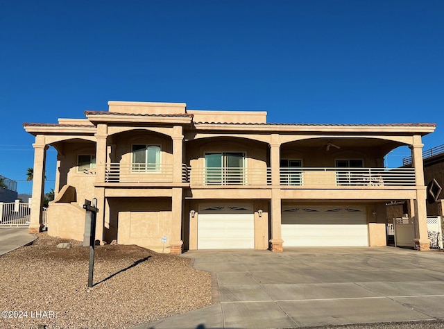 view of front of property with a garage and a balcony