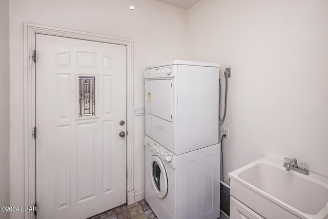 laundry room featuring stacked washer and dryer and sink