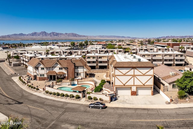 birds eye view of property featuring a water and mountain view and a residential view