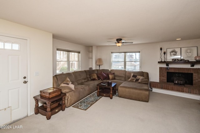 carpeted living room with built in features, ceiling fan, and a fireplace