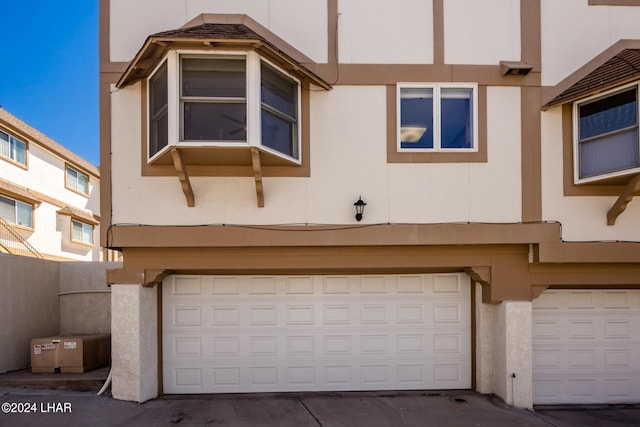 exterior space featuring stucco siding and an attached garage