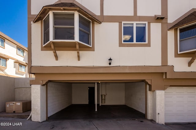 exterior space with a garage and stucco siding
