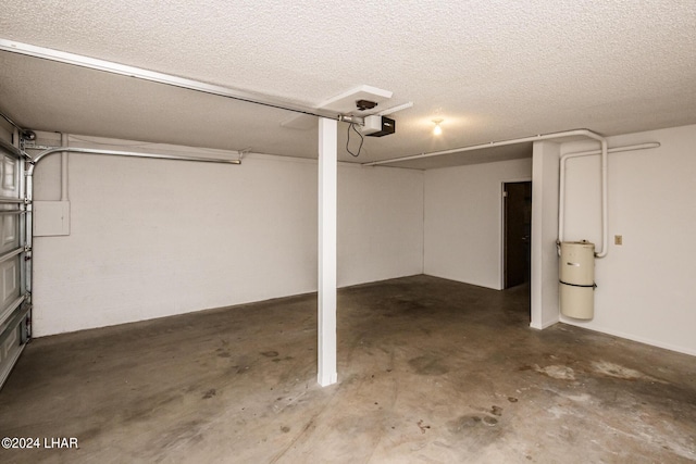 garage featuring concrete block wall and a garage door opener