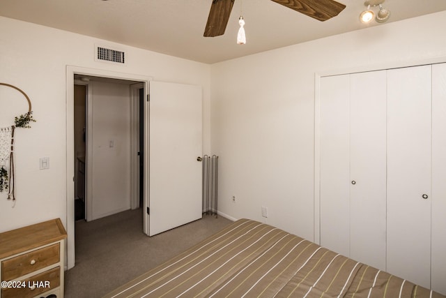 unfurnished bedroom featuring a closet, ceiling fan, carpet, and visible vents