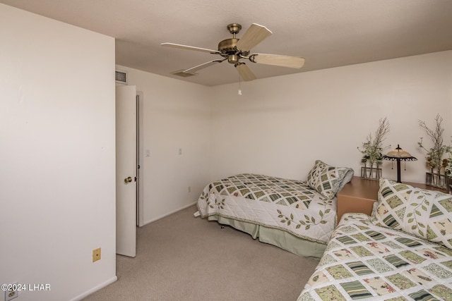 bedroom with carpet flooring, visible vents, and ceiling fan