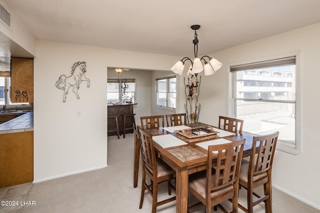dining area with visible vents, baseboards, and light carpet