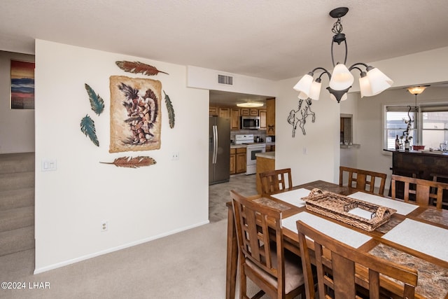 dining space with visible vents, baseboards, and light colored carpet