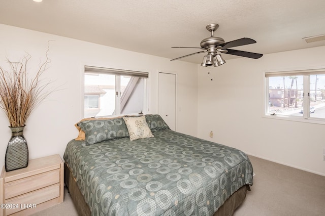 bedroom with a ceiling fan, carpet, and visible vents