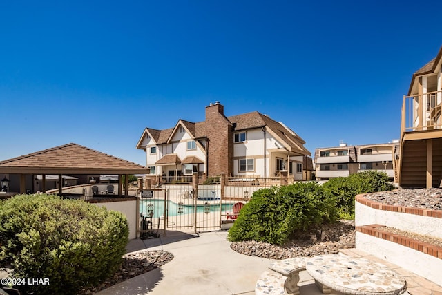 pool featuring a gazebo, a patio area, and fence