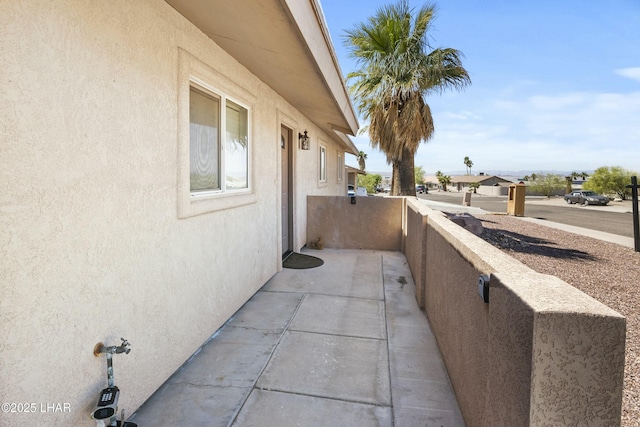 view of property exterior with a balcony and stucco siding