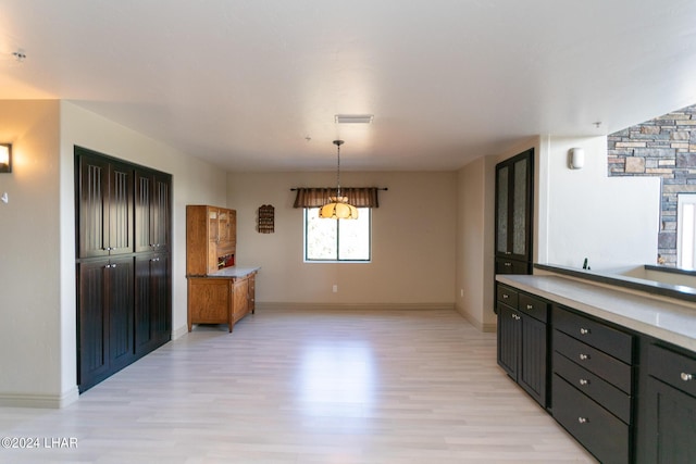 unfurnished dining area with light wood-type flooring