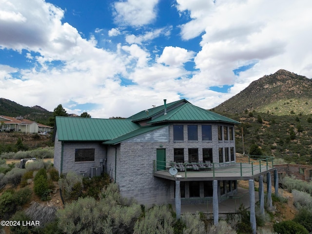 back of house with a mountain view, a patio area, and central air condition unit