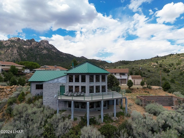 rear view of house featuring a mountain view