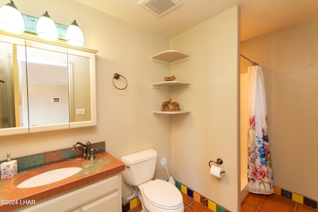 bathroom featuring a shower with curtain, vanity, toilet, and tile patterned flooring