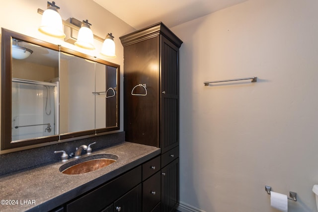 bathroom with vanity and a shower with door