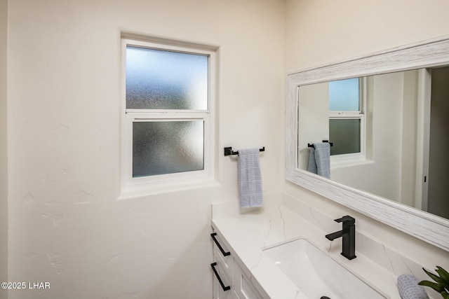 bathroom with vanity and a wealth of natural light