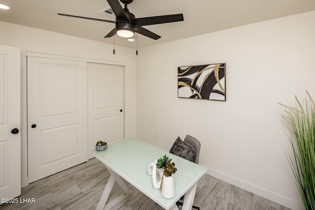 office space featuring recessed lighting, visible vents, light wood-style floors, a ceiling fan, and baseboards