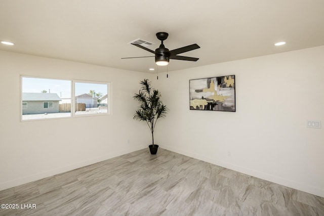 spare room featuring a ceiling fan, recessed lighting, visible vents, and baseboards