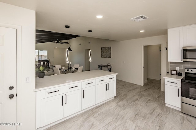 kitchen with visible vents, appliances with stainless steel finishes, a peninsula, light countertops, and white cabinetry