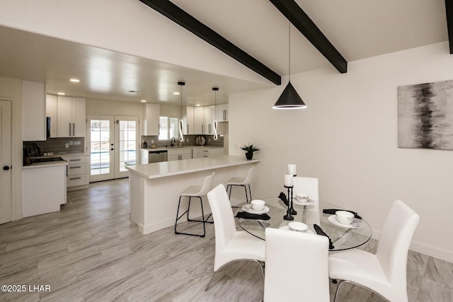 dining space with vaulted ceiling with beams, french doors, baseboards, and recessed lighting