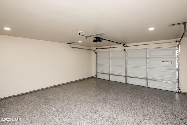 garage with a garage door opener, recessed lighting, and baseboards