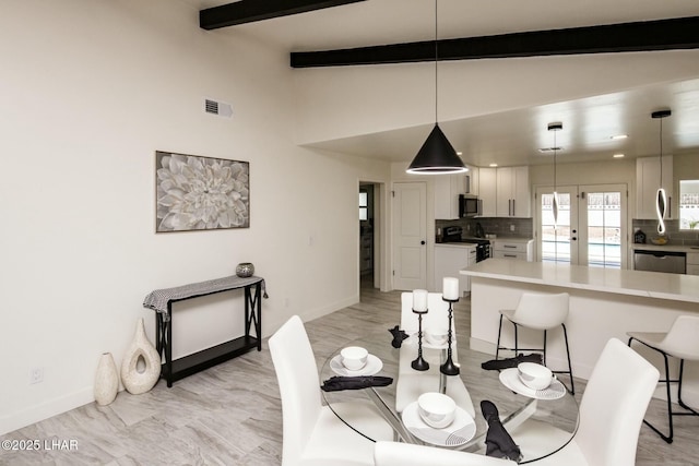 dining area featuring french doors, visible vents, vaulted ceiling with beams, and baseboards