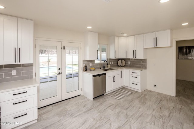 kitchen featuring a sink, white cabinets, stainless steel dishwasher, and french doors