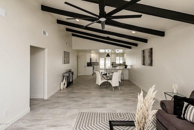 dining space featuring a ceiling fan, visible vents, vaulted ceiling with beams, and baseboards