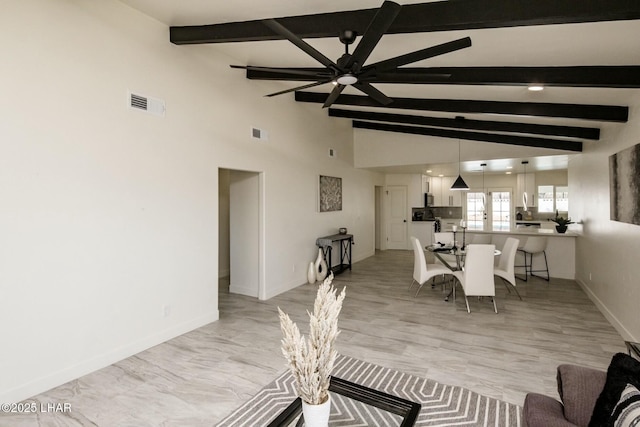 dining space with vaulted ceiling with beams, ceiling fan, visible vents, and baseboards