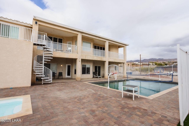 view of pool with a fenced in pool, stairs, a patio, and fence