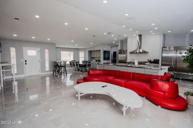 living area featuring vaulted ceiling, recessed lighting, visible vents, and marble finish floor