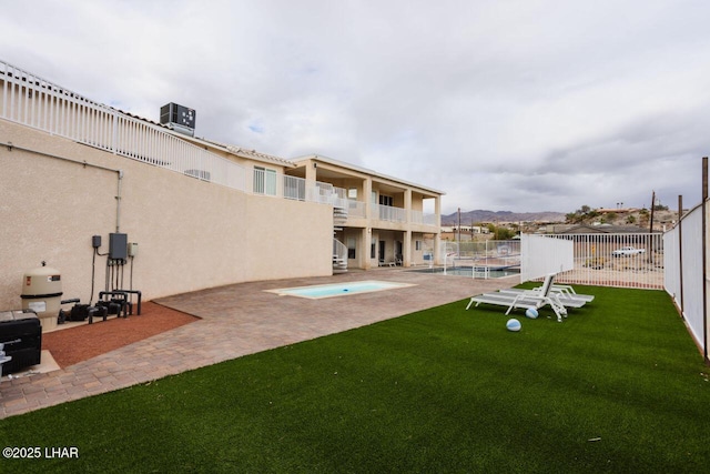 exterior space featuring a balcony, cooling unit, fence, a fenced in pool, and a patio area