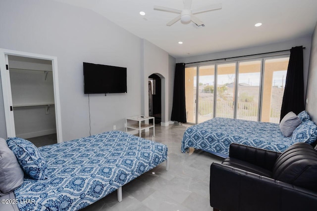 bedroom with a spacious closet, lofted ceiling, recessed lighting, arched walkways, and access to outside