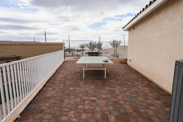 view of patio with outdoor dining area, cooling unit, and fence