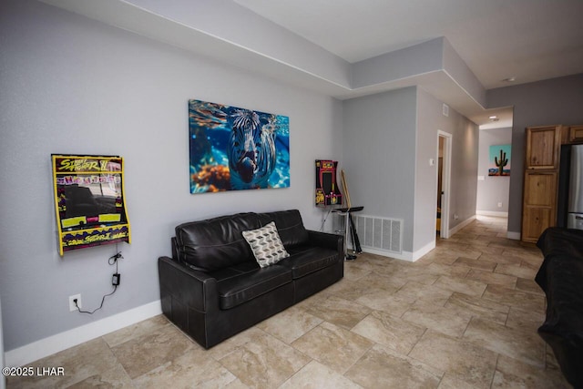 living room with visible vents and baseboards