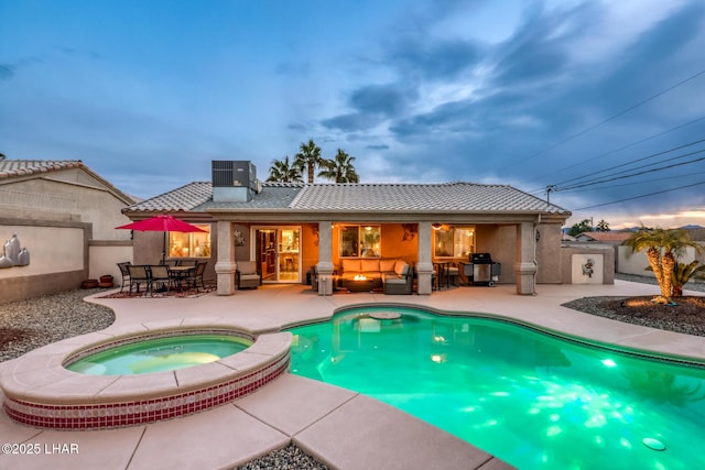 pool at dusk featuring an in ground hot tub, a grill, a patio area, and central air condition unit