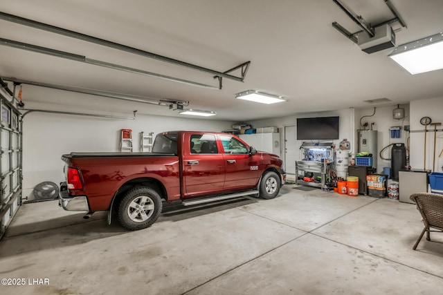 garage with a garage door opener and water heater