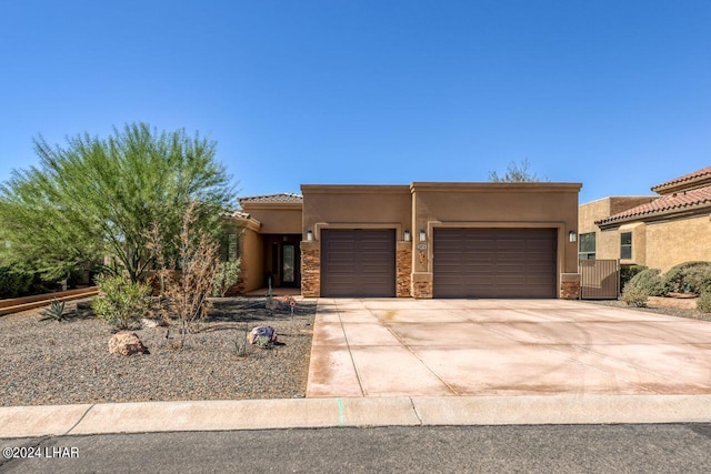 pueblo-style house featuring a garage