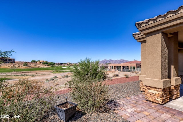 view of yard with a mountain view and a patio area